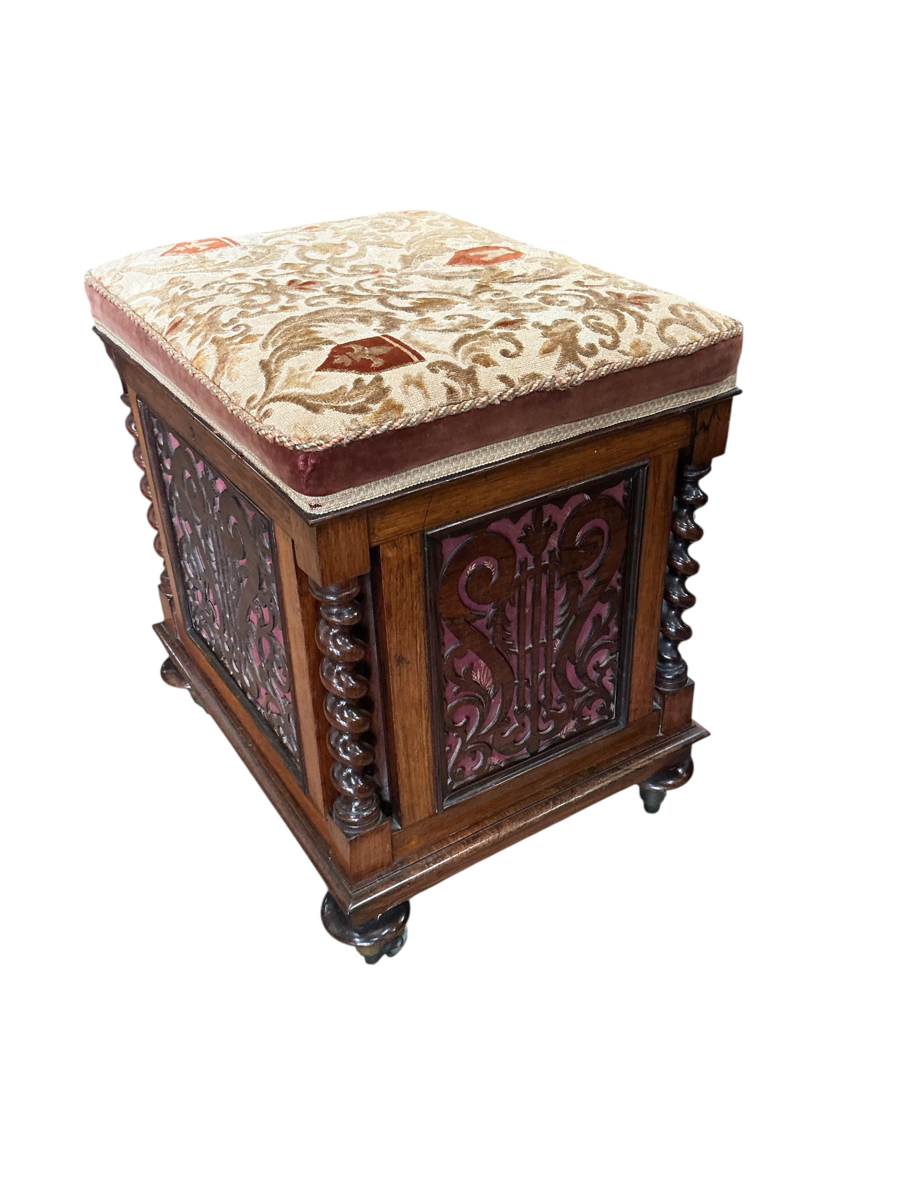 A Victorian rosewood upholstered box seat music stool with fret cut panels, width 47cm, depth 38cm, height 52cm